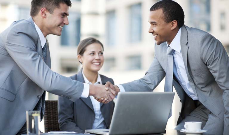 Businessmen shaking hands with smiling face